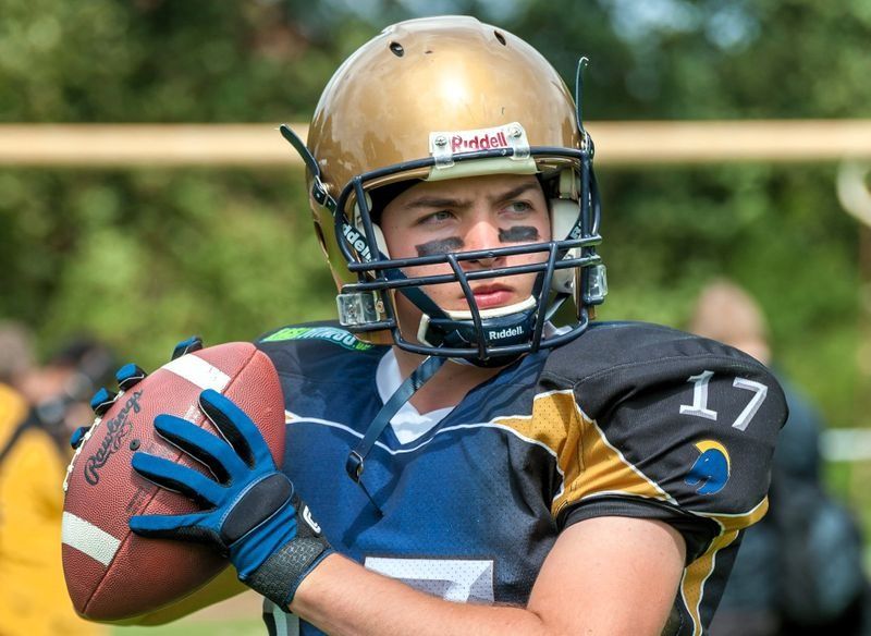 a male football player about to throw a football