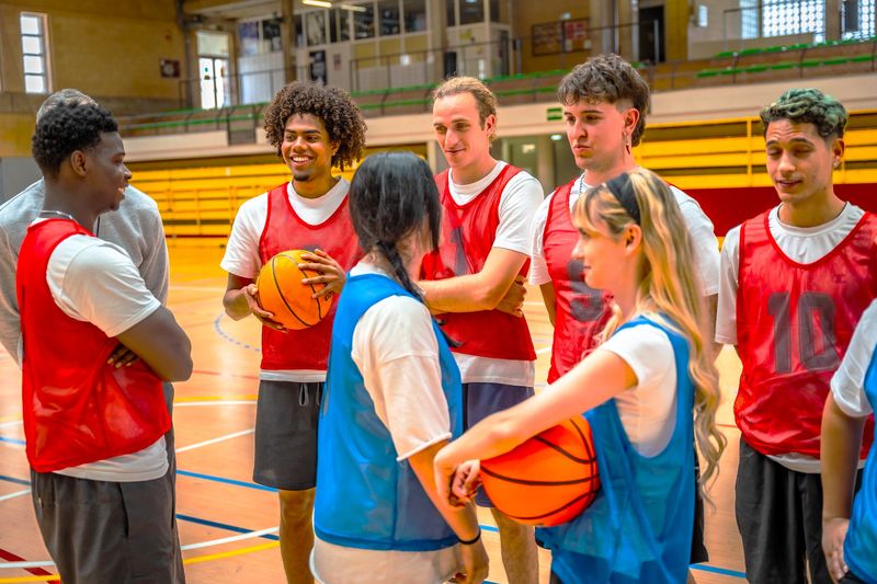 a youth basketball team standing in a group wearing pinnies