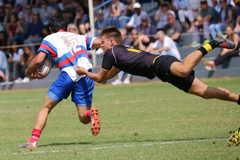 a rugby player about to tackle a rugby player