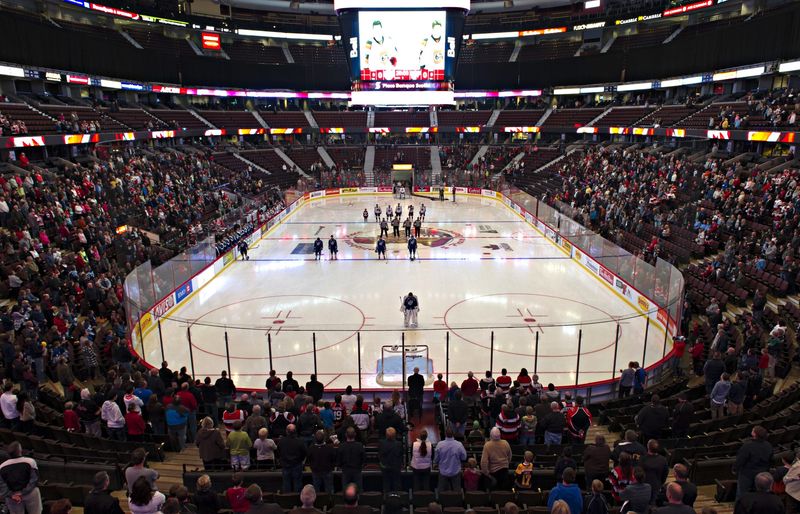 a hockey arena with spectators in the stands