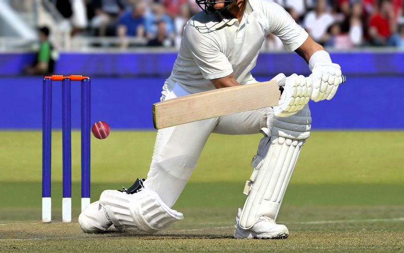 a cricket player about to hit a cricket ball