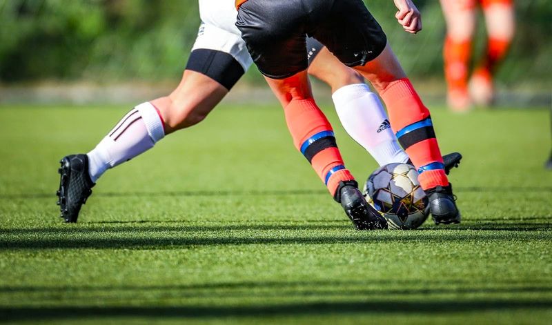 a soccer player trying to beat an opposing soccer player