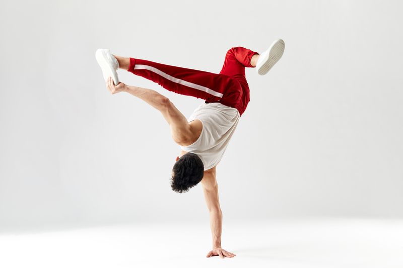 a break dancer doing a one handed dance move