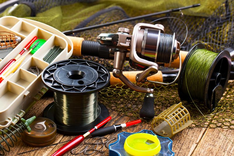 a collection of fishing gear on a wooden table