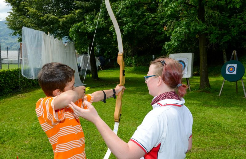 a beginner archer receiving advice by an archery instructor