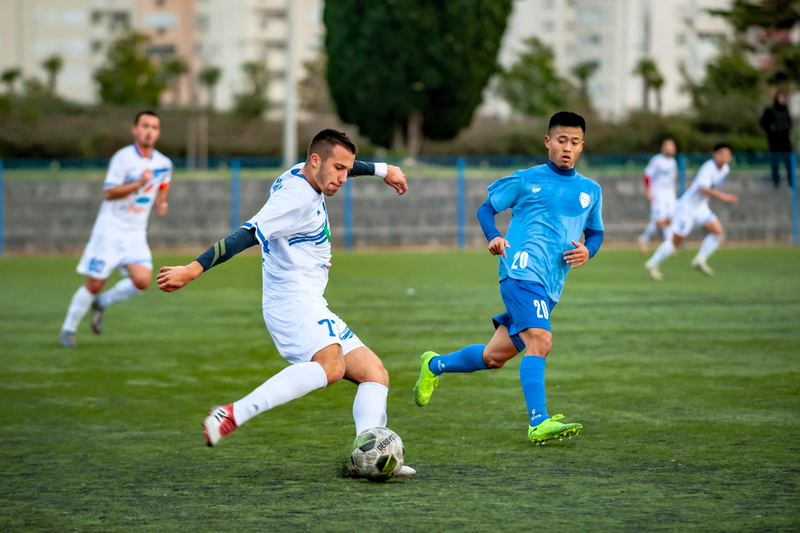 a soccer player about to kick a soccer ball
