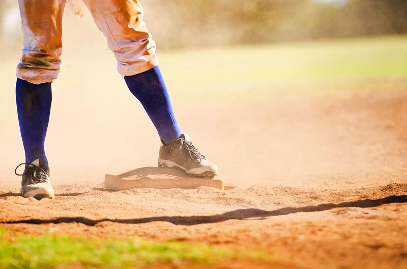 a softball player standing on a base