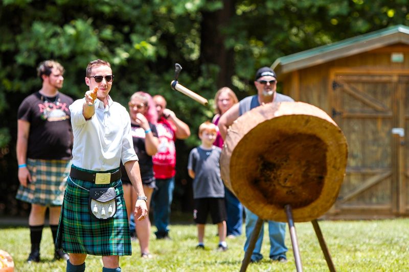 a man making a single-handed axe throw