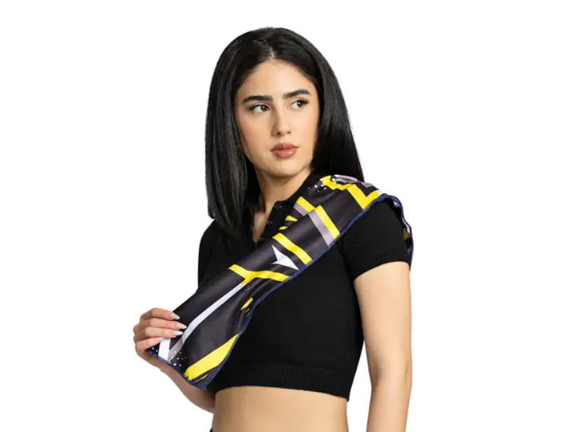 an adult female with a black and yellow cooling towel draped over her shoulder