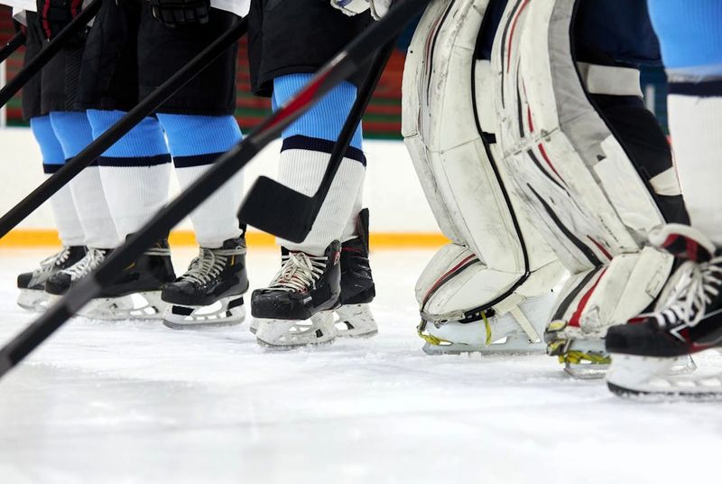 a close up of a hockey team's hockey socks on an ice rink