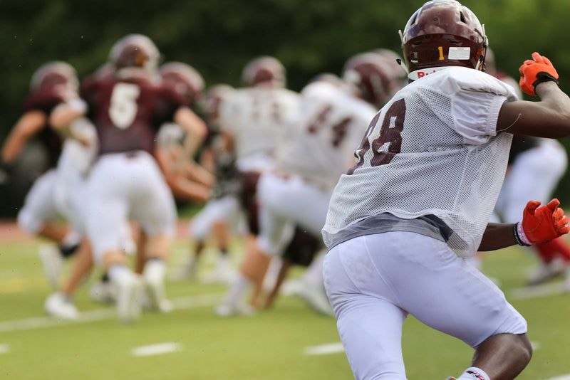 a football player running with a football