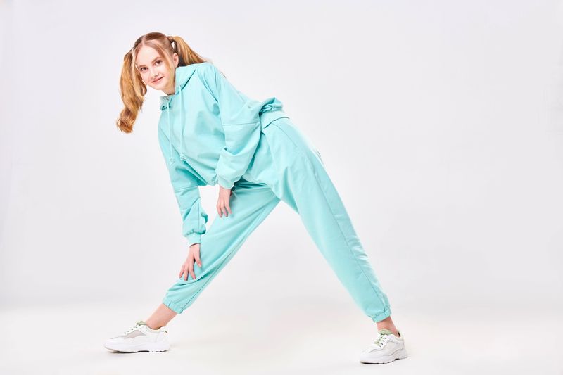 a young female wearing a matching hoodie and jogger pants