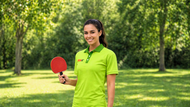 an adult female holding a ping pong paddle in her right hand