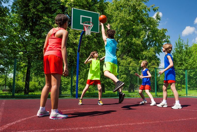 teens playing basketball outside