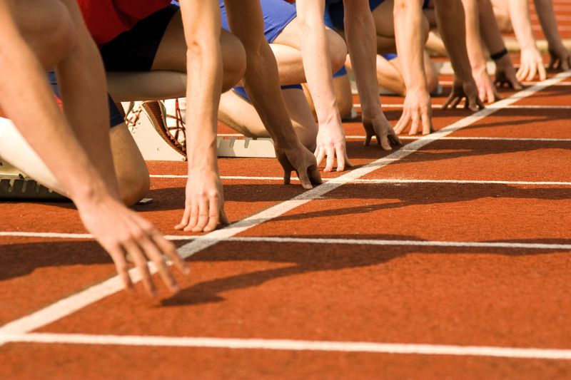 track and field athletes at the start line