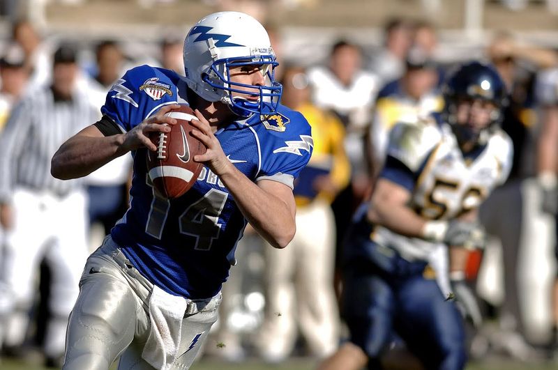 Football Player Carrying a Football
