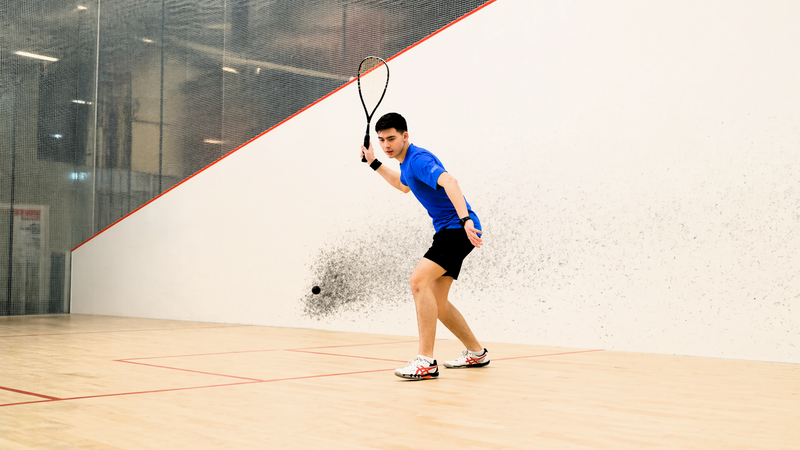 an adult male playing squash