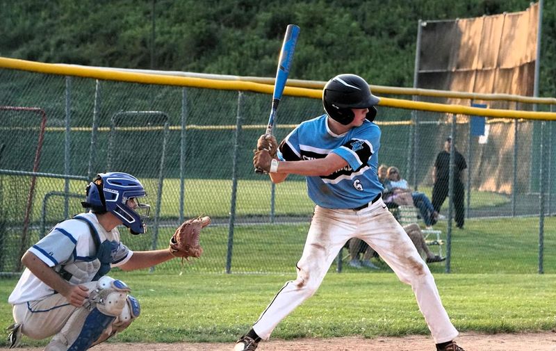 a baseball batter hitting a baseball pitch