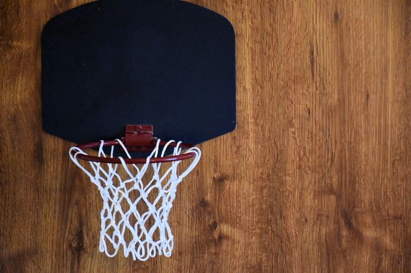a mini basketball hoop on a wooden wall