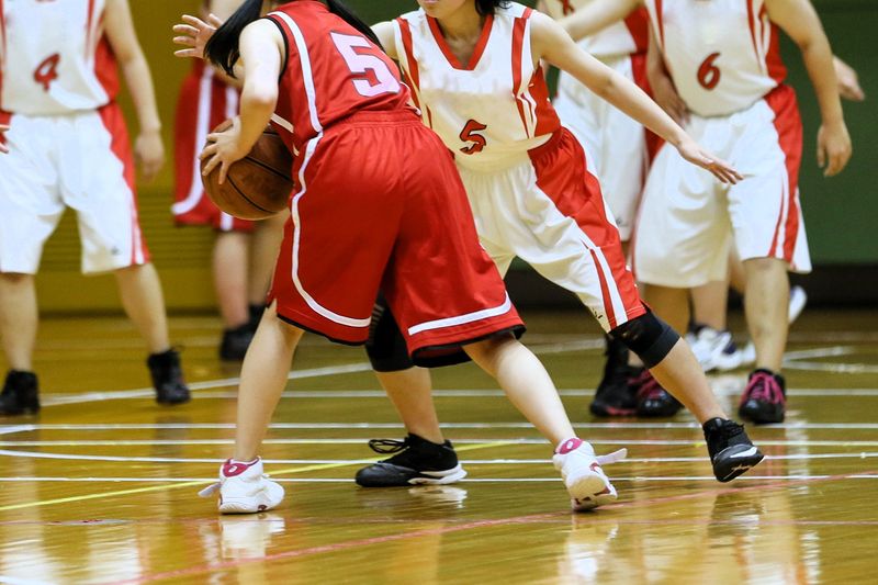 two youth female basketball teams playing basketball