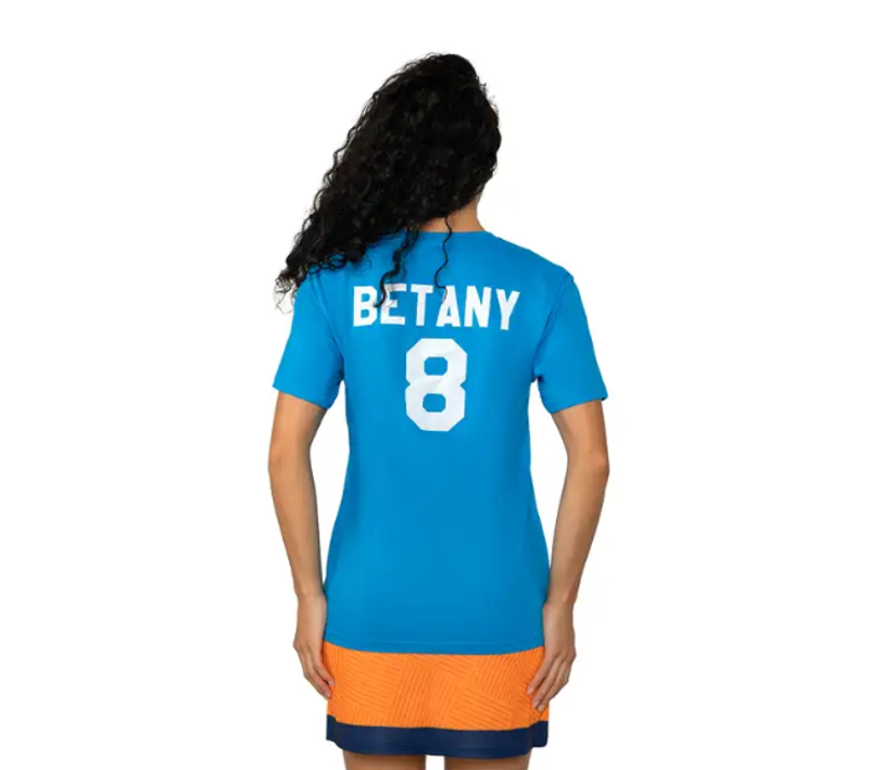 an adult female showing the back side of her cheerleading t-shirt
