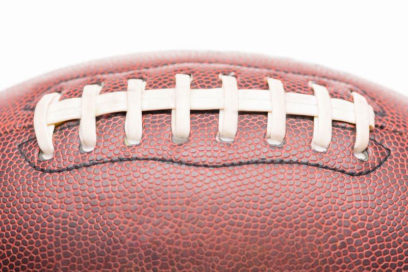a close up image of an American football stitching