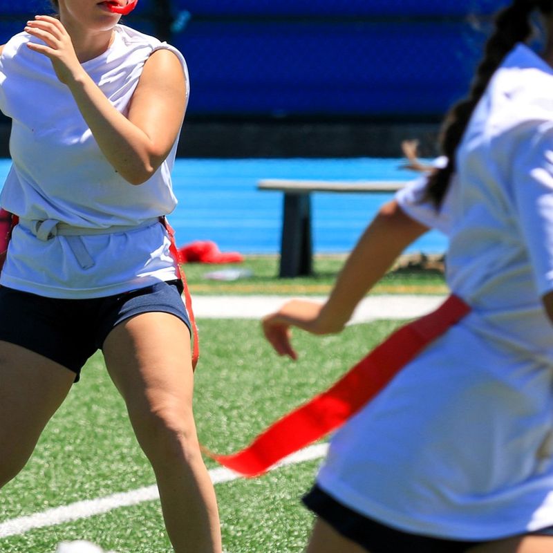 a flag football quarterback about to throw the football