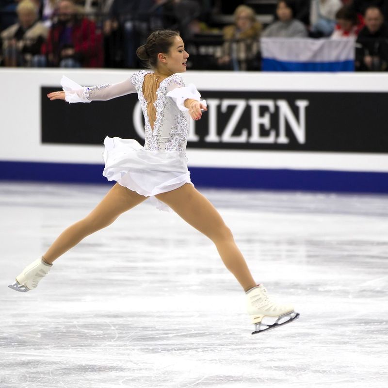 a female figure skater jumping on ice