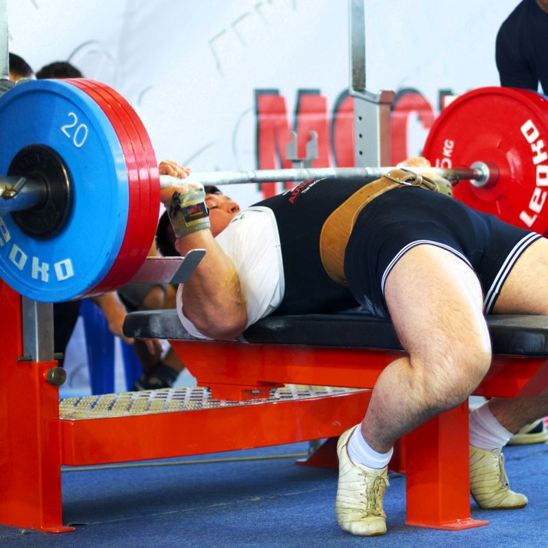 a powerlifting performing a bench press lift at an event