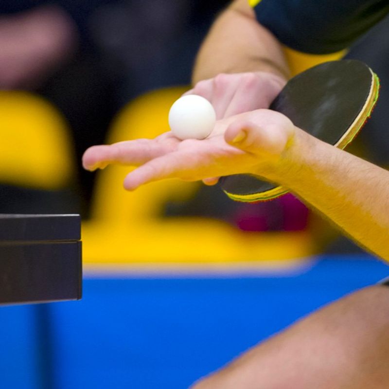 a professional ping pong player about to serve