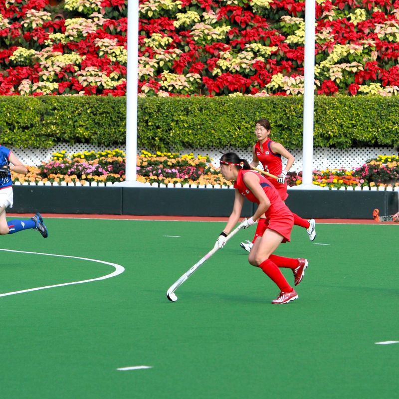a field hockey player carrying the hockey ball during a match