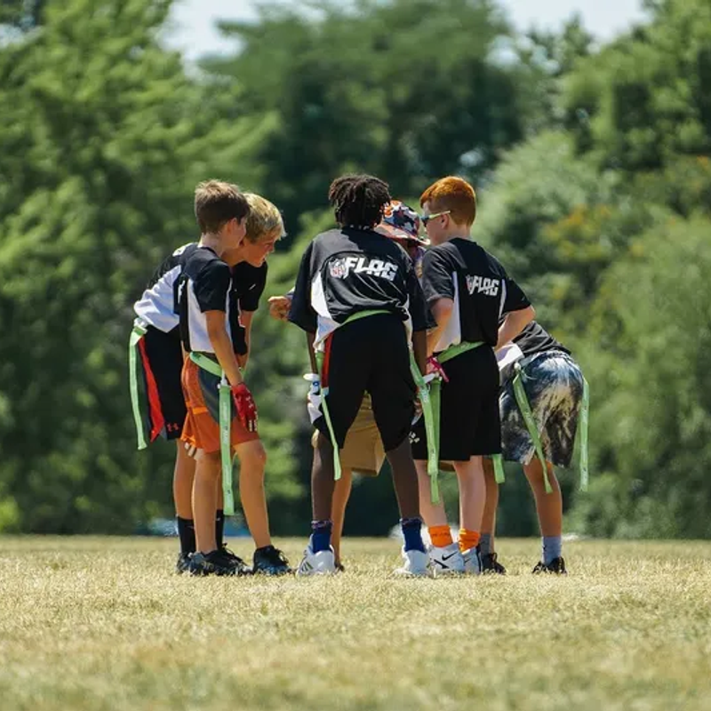 Flag football players in a huddle