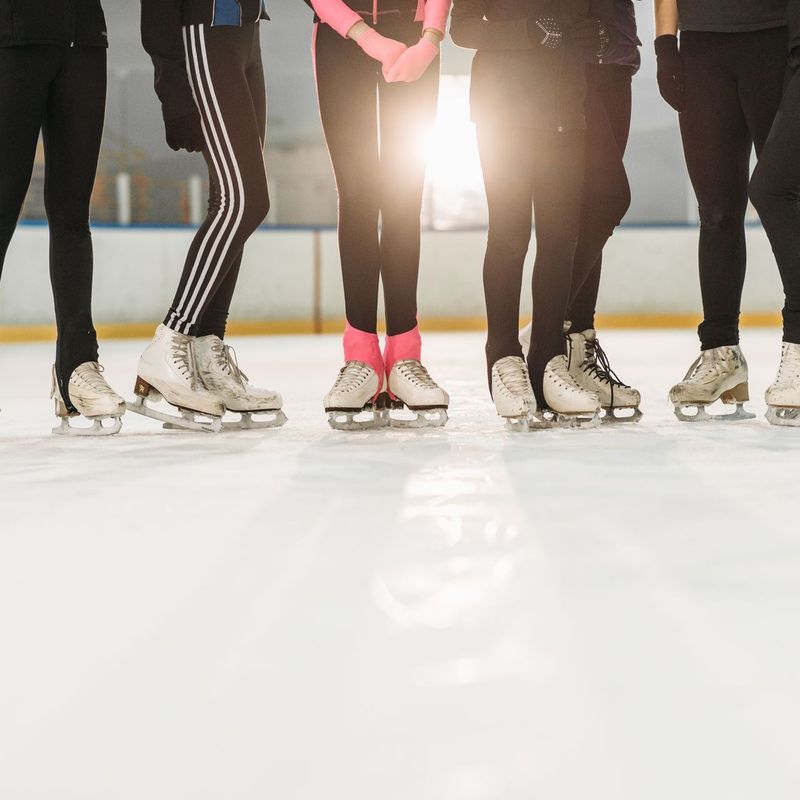 Row of youth figure skaters on ice