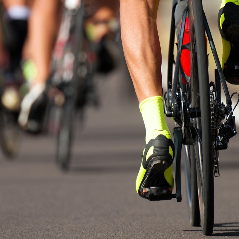 a group of cyclists cycling on a road