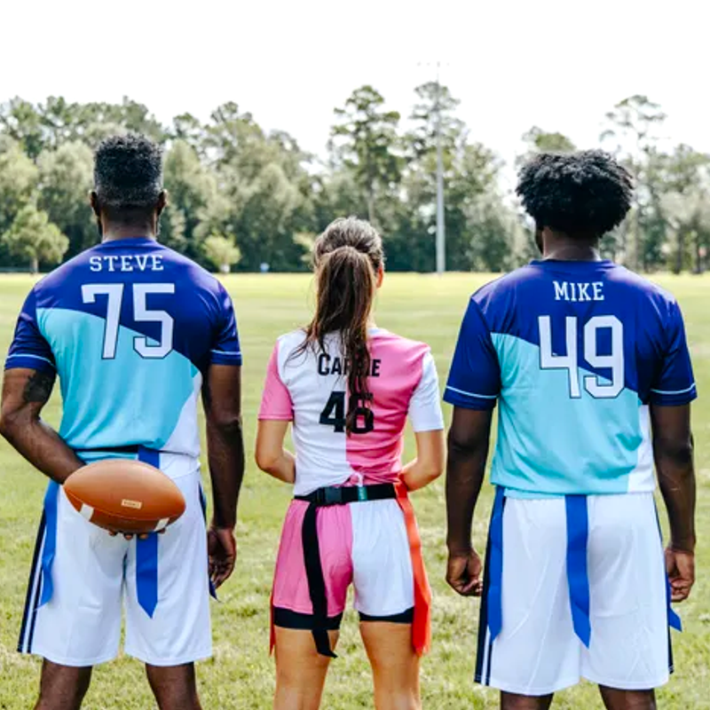 three flag football platers facing forward