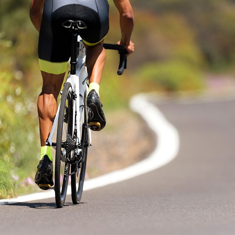 a male adult road cyclist cycling on a road
