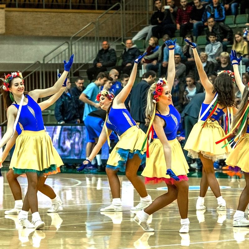 a group of cheerleaders performing a routine in front of spectators