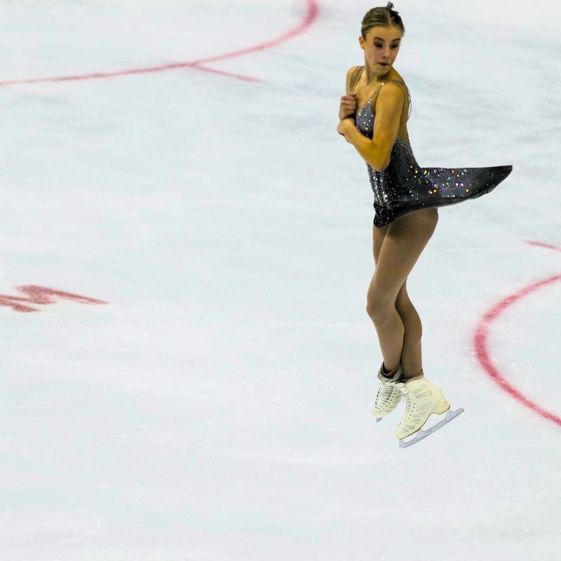 a figure skating jumping on ice